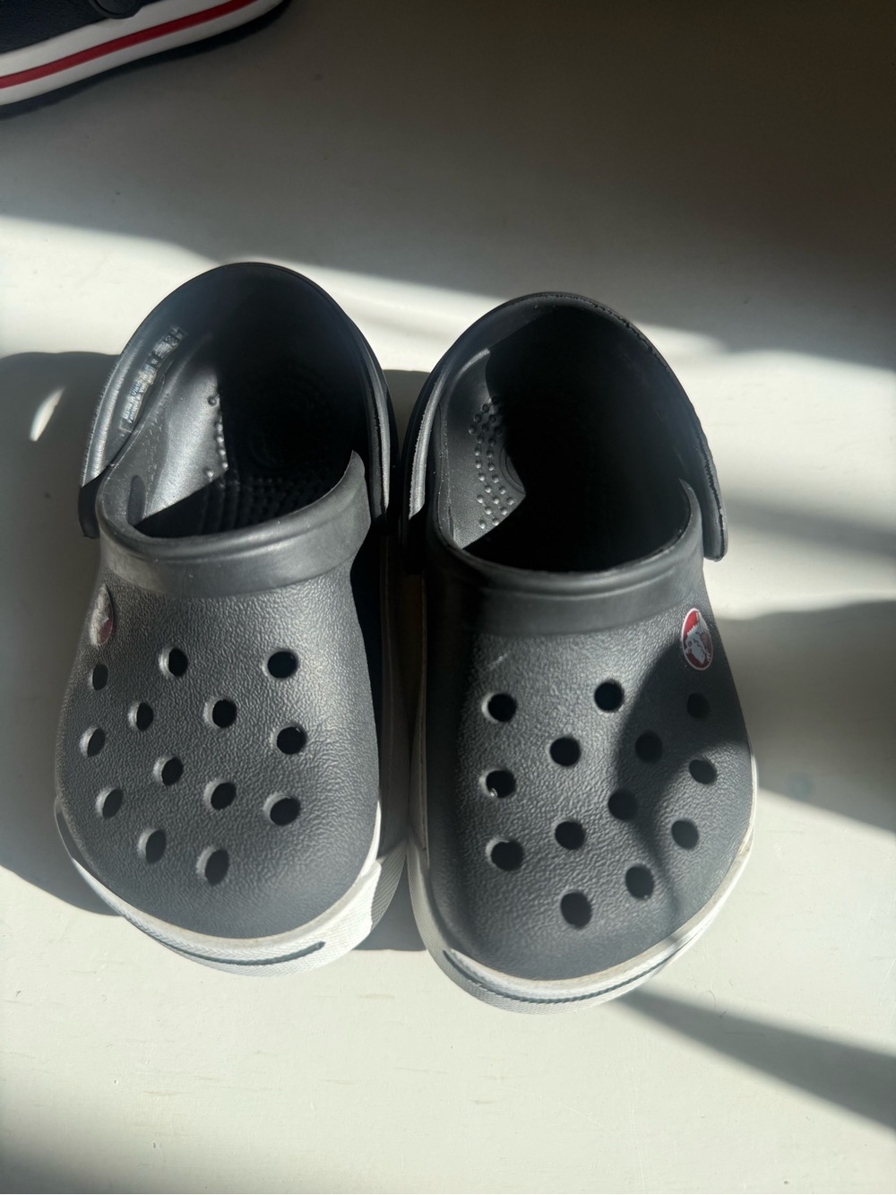 CROCS Kids Black Clogs with White Trim